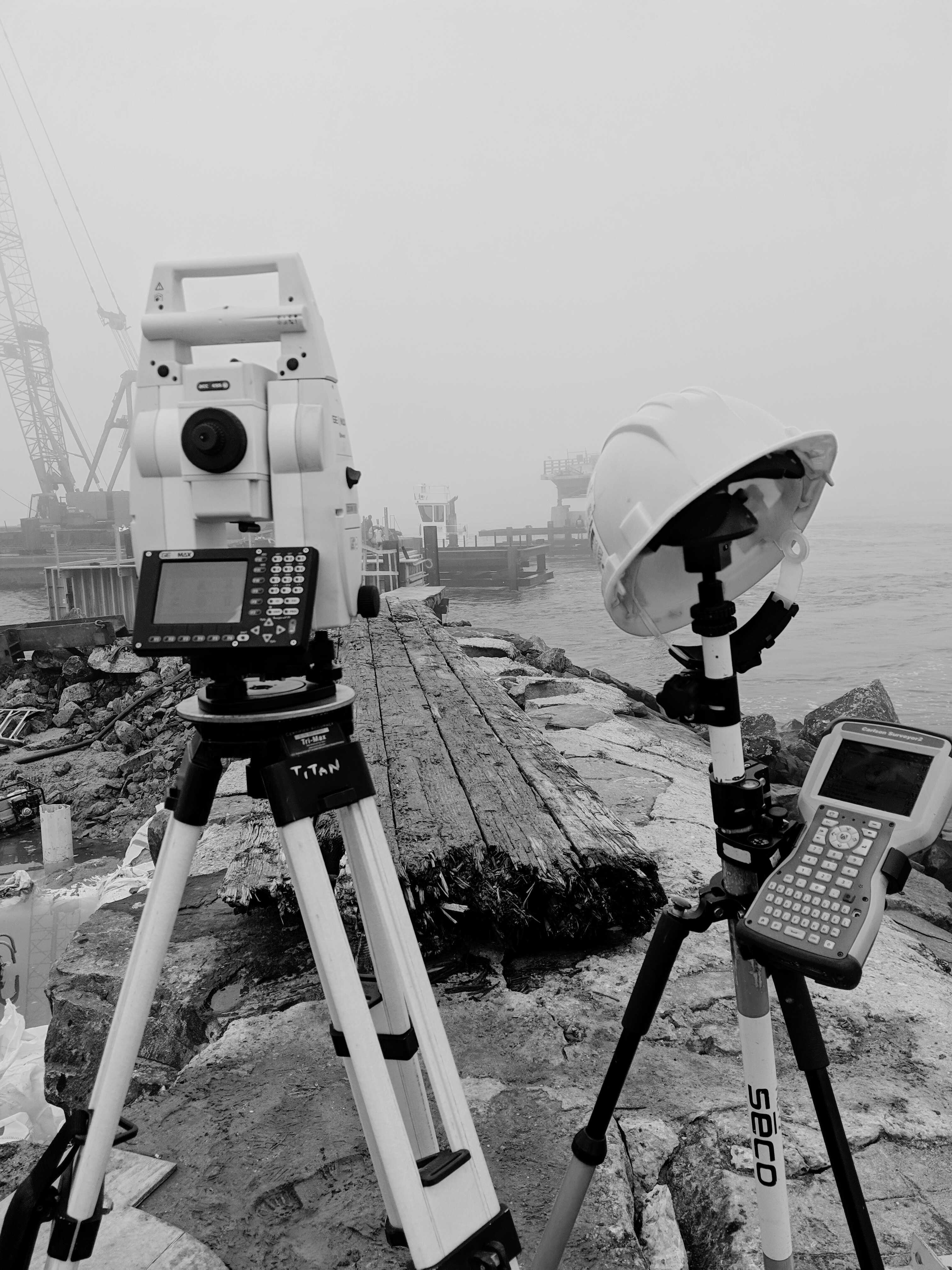 Professional surveying equipment at waterfront